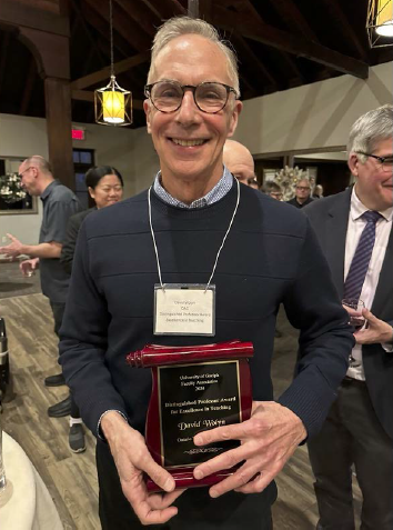 Dr. David Wolyn with the Faculty Association's Distinguished Professor Award for Excellence