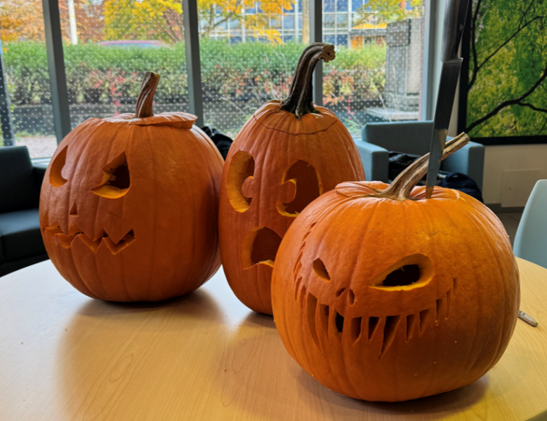 A trio of pumpkins carved by Plant Ag Office staff