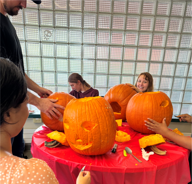 Grad students hard at work carving pumpkins